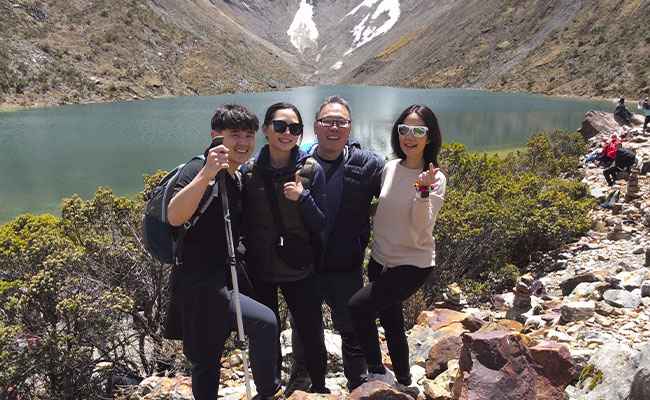 Tourists at Humantay Lake Peru – turquoise glacial lake near Cusco