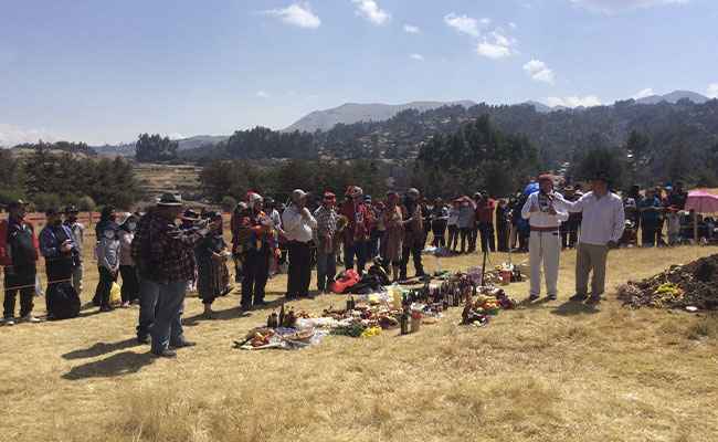 Andean shaman performing Pachamana ceremony in sacred valley Peru