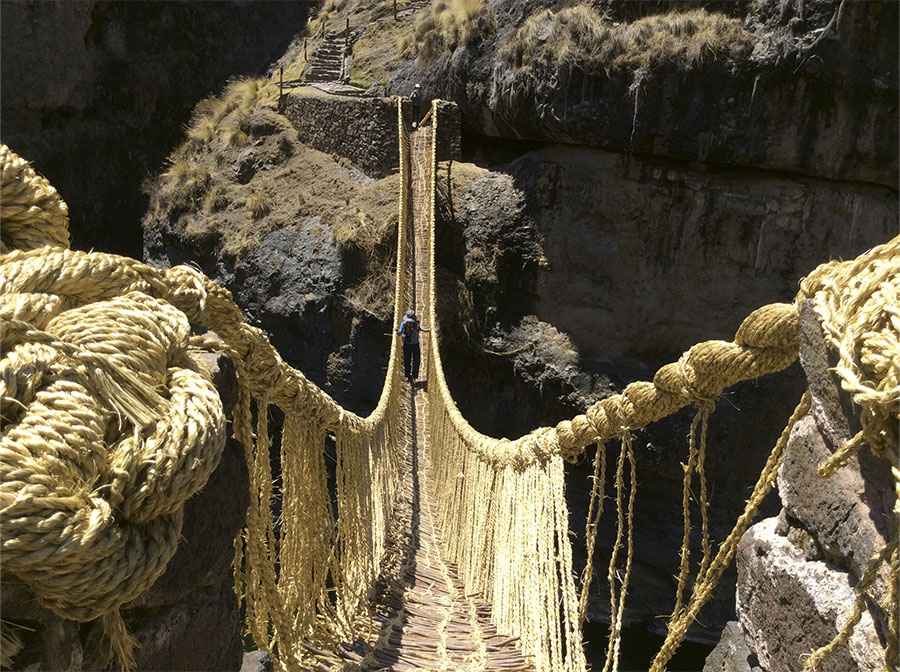 Tourists crossing Qeswachaka Bridge on full day tour from Cusco